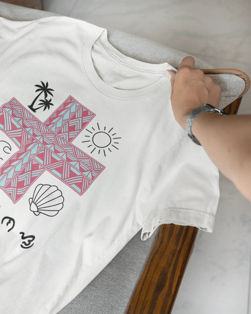 Close-up of a white Pilipinas shirt draped over a chair, highlighting the Baybayin script details.
