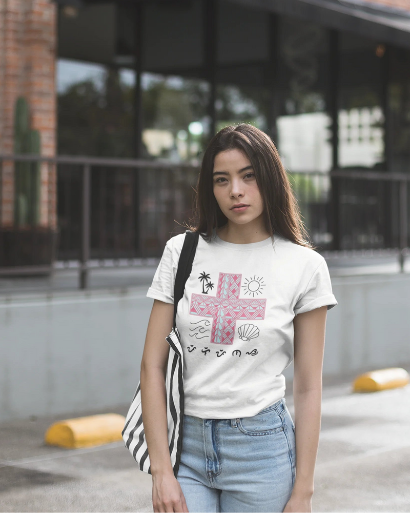 White Pilipinas shirt worn in front of a brick building, showcasing the Baybayin tribal cross design.