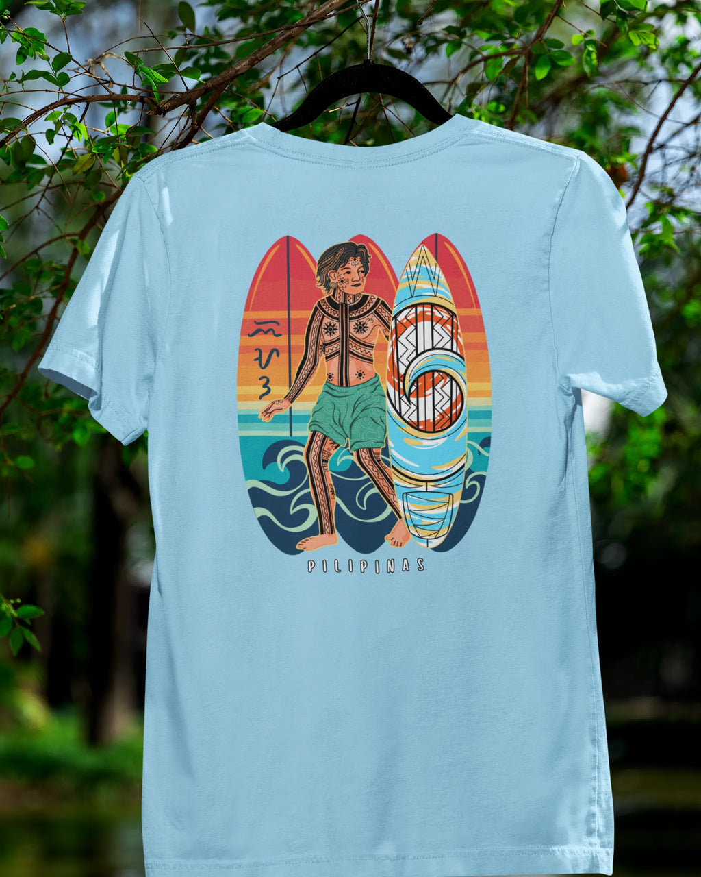 Ocean blue Filipino surf shirt with Badlit script on a hanger in a nature setting
