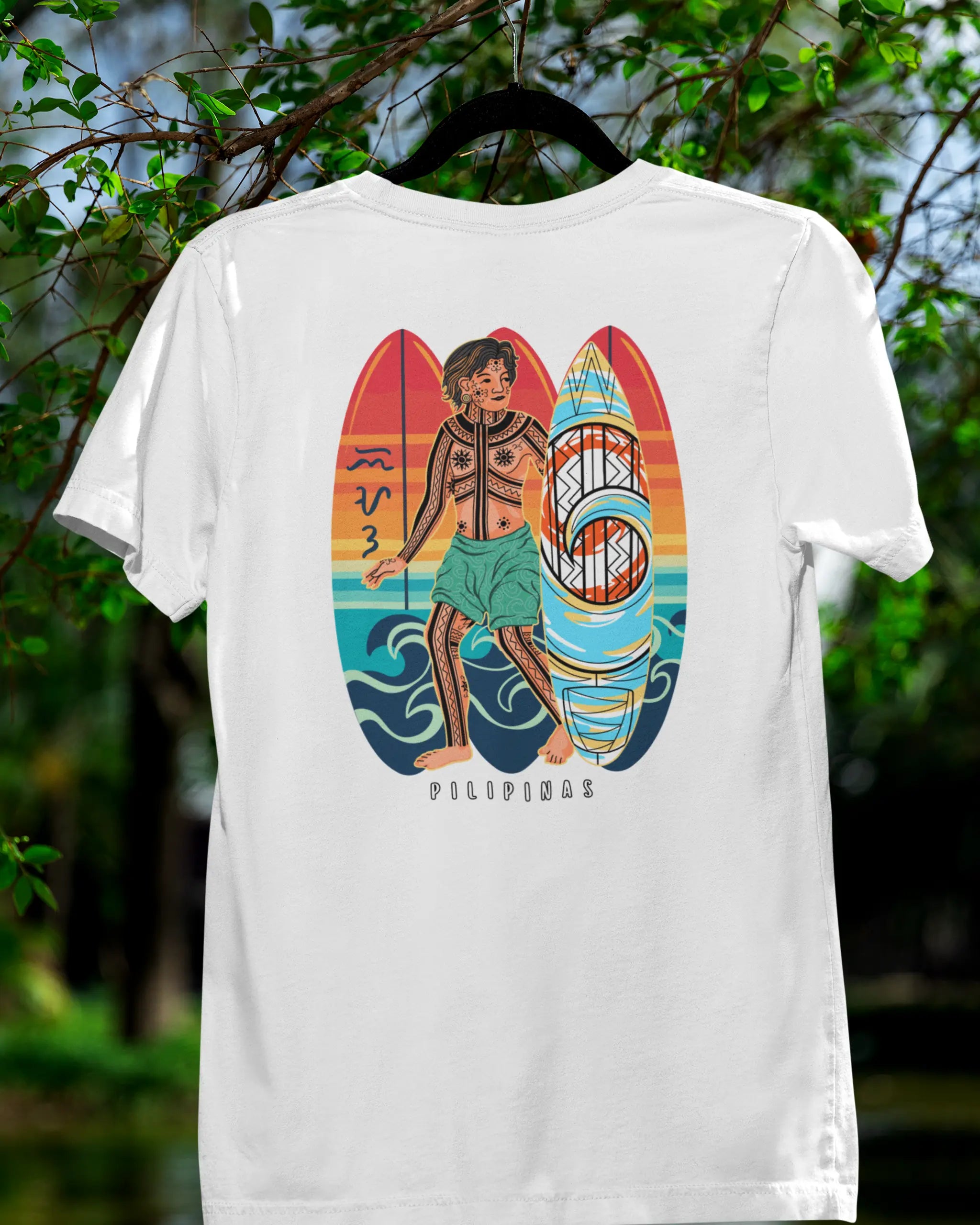 White Surfin' Siargao Badlit tee on a hanger in a nature setting