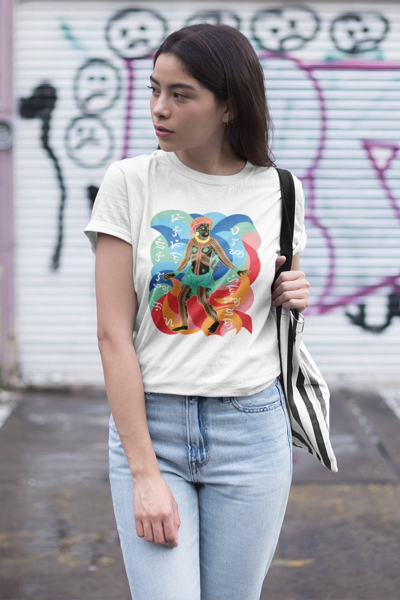 Filipina wearing a white Pinoy t-shirt with a colorful graphic design showing a Visayan Figure and pre-colonial script