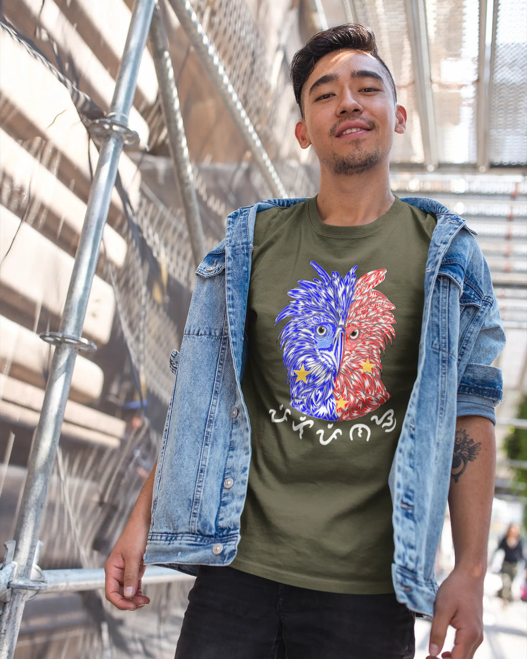 Filipino man in an army green Pinoy pride shirt, Philippine Eagle design, on a footbridge