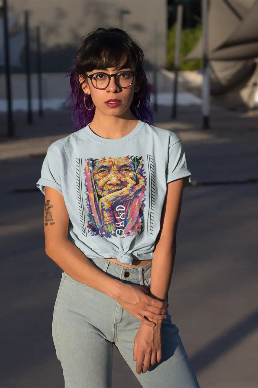 2nd gen Pinay wearing a baby blue Apo Whang Od batok tribute tee with bold multicolor artwork and Batikan Baybayin detail
