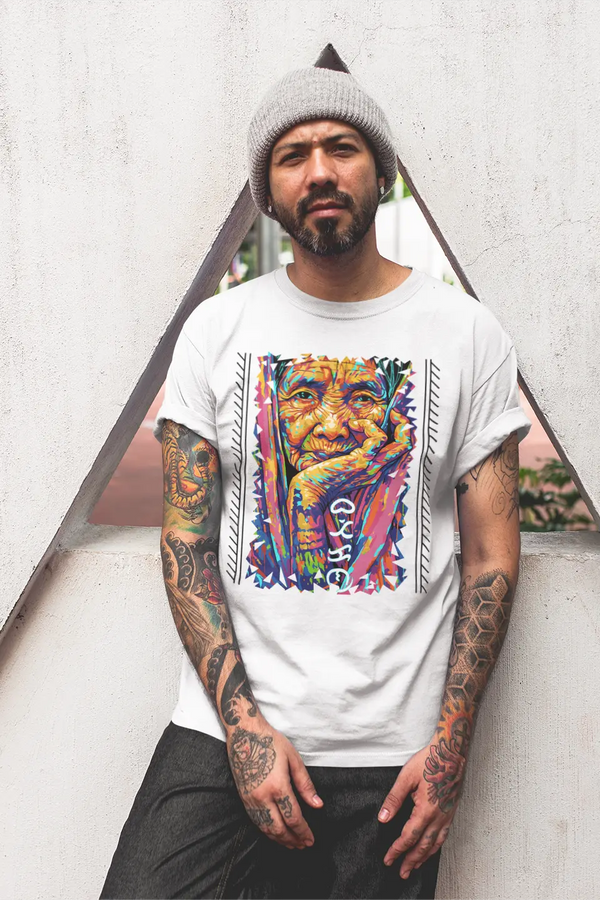 Filipino Man wearing a cotton Apo Whang Od T-shirt with vibrant tattoo art tribute and Baybayin Batikan lettering on it.