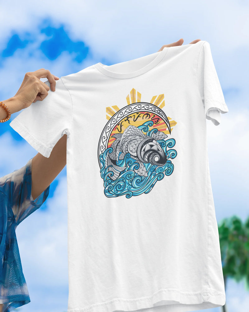 White filipino tribal art shirt held up against the sky, showing the koi and sun graphic.