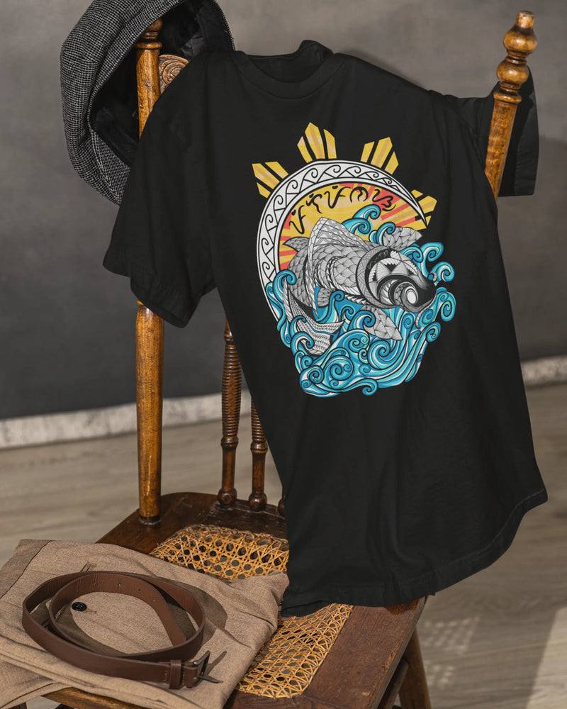 Black Pilipinas koi shirt on a vintage chair, close-up of the filipino tribal art design.