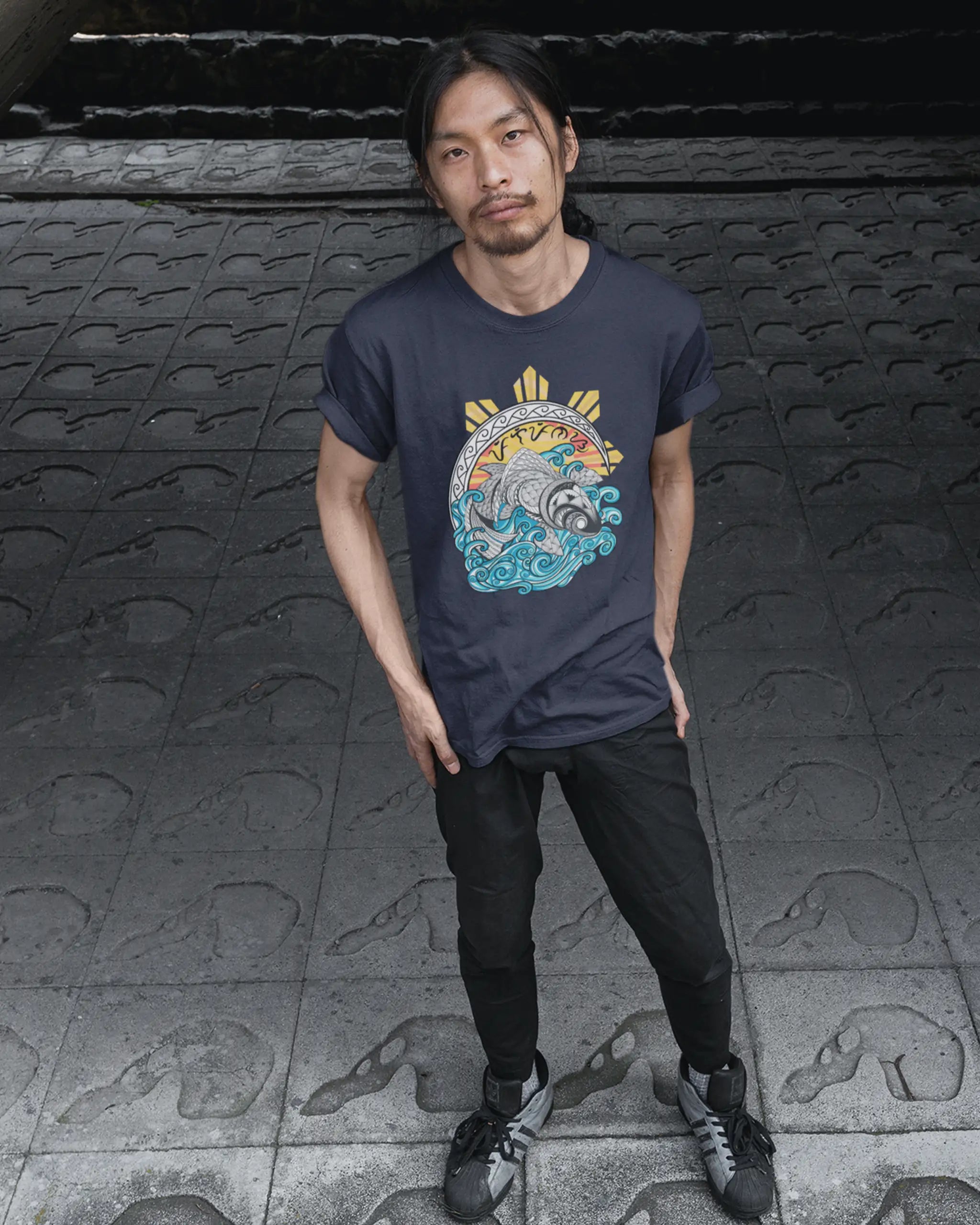 Navy Baybayin koi shirt worn by a pinoy man outdoors, filipino tribal art shirt with ocean wave design.