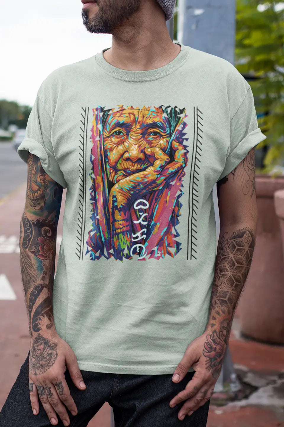 Filipino heritage T-shirt with Apo Whang Od portrait, colorful batok design, and Baybayin text
