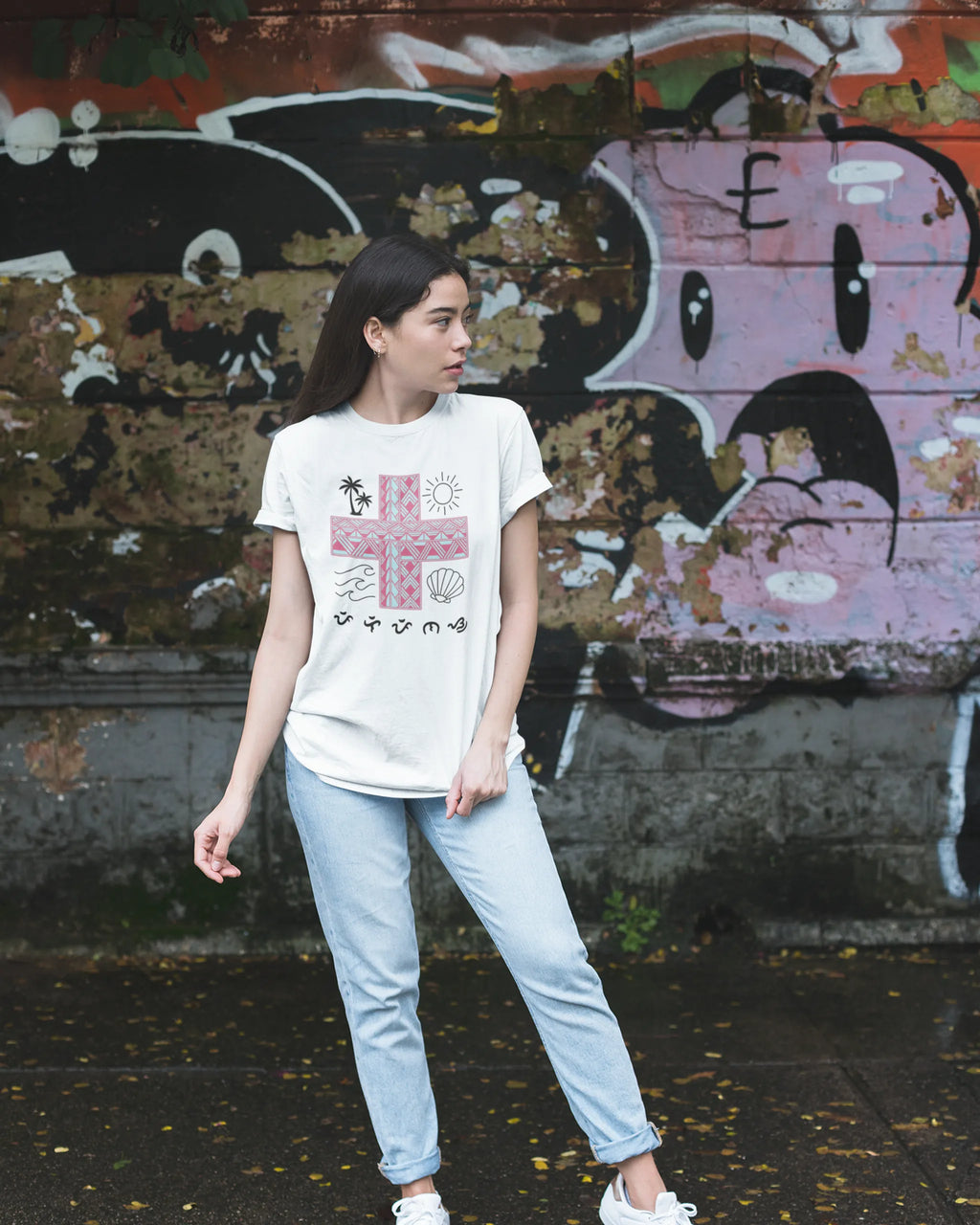 White Pilipinas shirt worn against a graffiti wall, pairing street style with Baybayin heritage design.