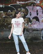 White Pilipinas shirt worn against a graffiti wall, pairing street style with Baybayin heritage design.