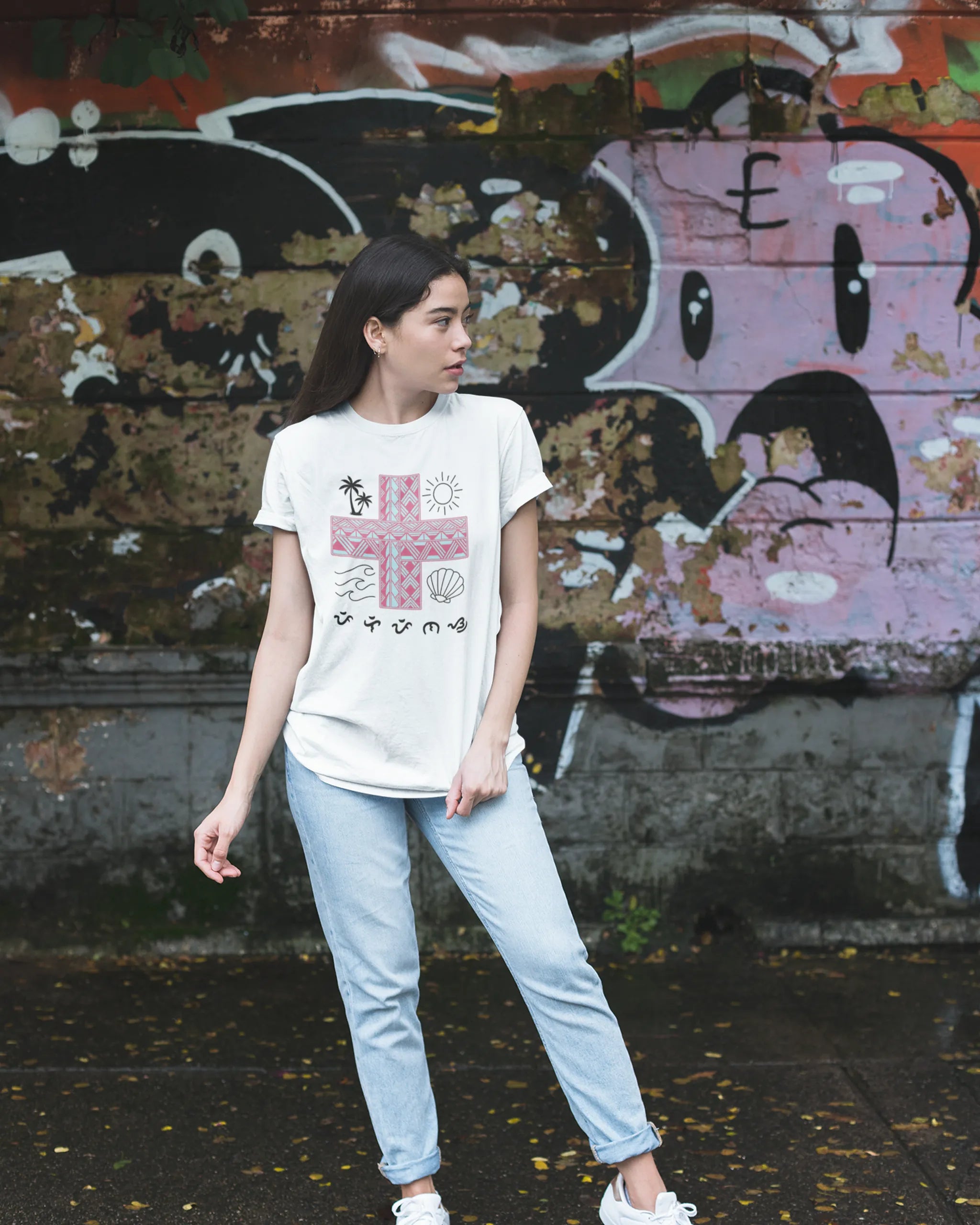 White Pilipinas shirt worn against a graffiti wall, pairing street style with Baybayin heritage design.