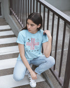 Light blue Pilipinas shirt worn on outdoor stairs, a casual look for this Baybayin filipino heritage shirt.