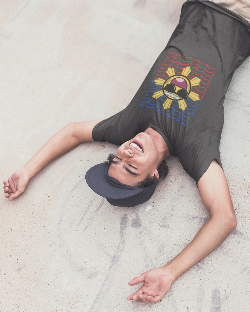 Pinoy skater laughing on the ground in a Baybayin t-shirt, playful filipino streetwear brand energy.
