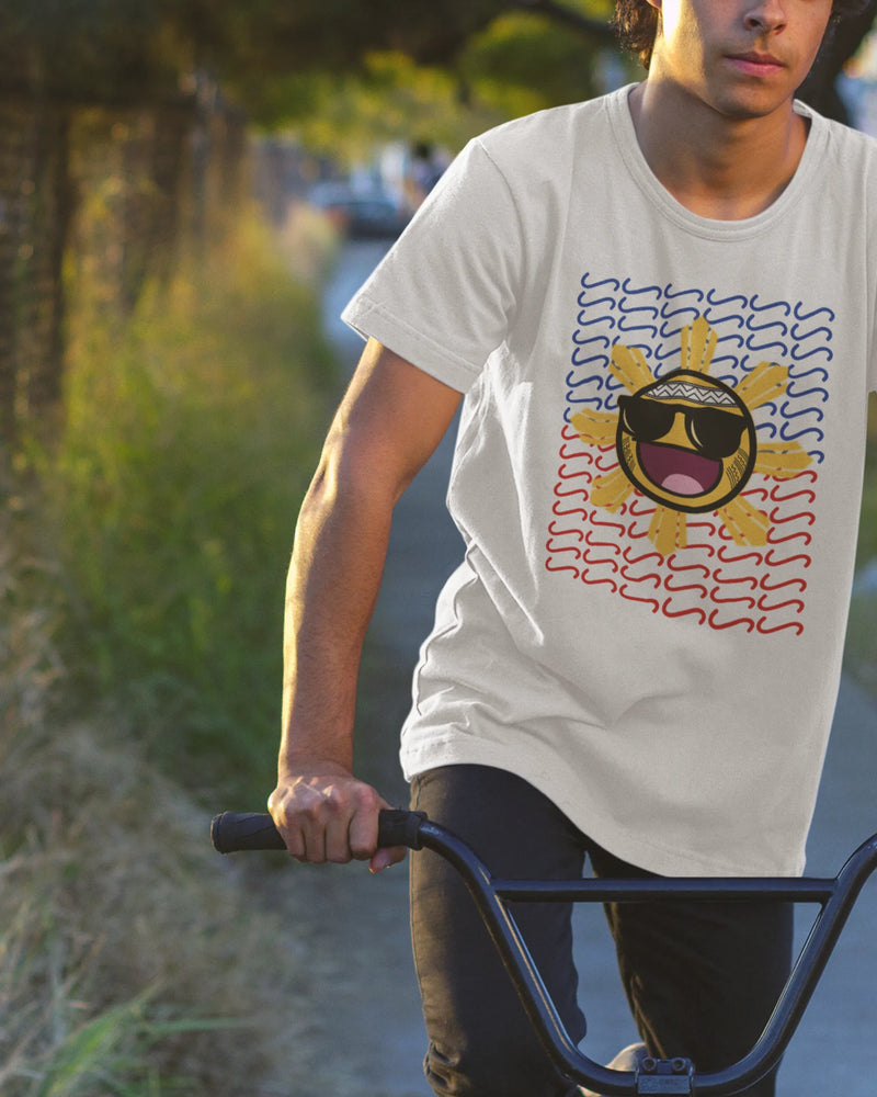 Young Pinoy riding a bike in a Baybayin shirt, laid-back filipino streetwear for everyday wear.