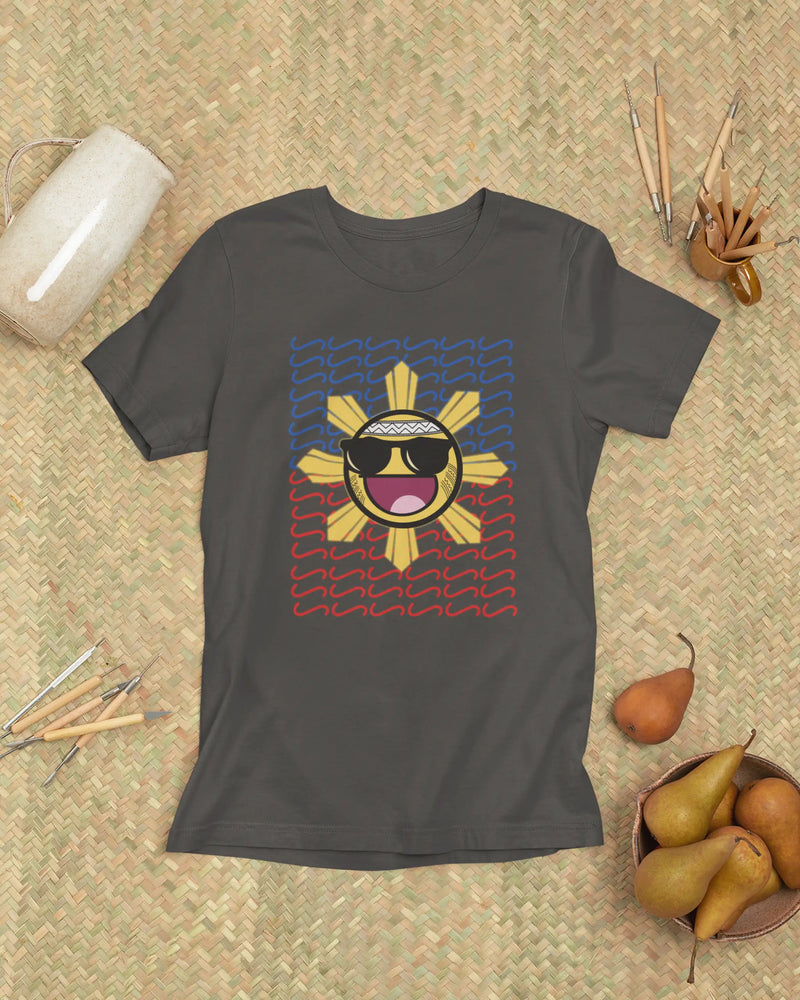 Dark grey Baybayin t-shirt laid flat on a woven banig, filipino streetwear with a laughing sun design.