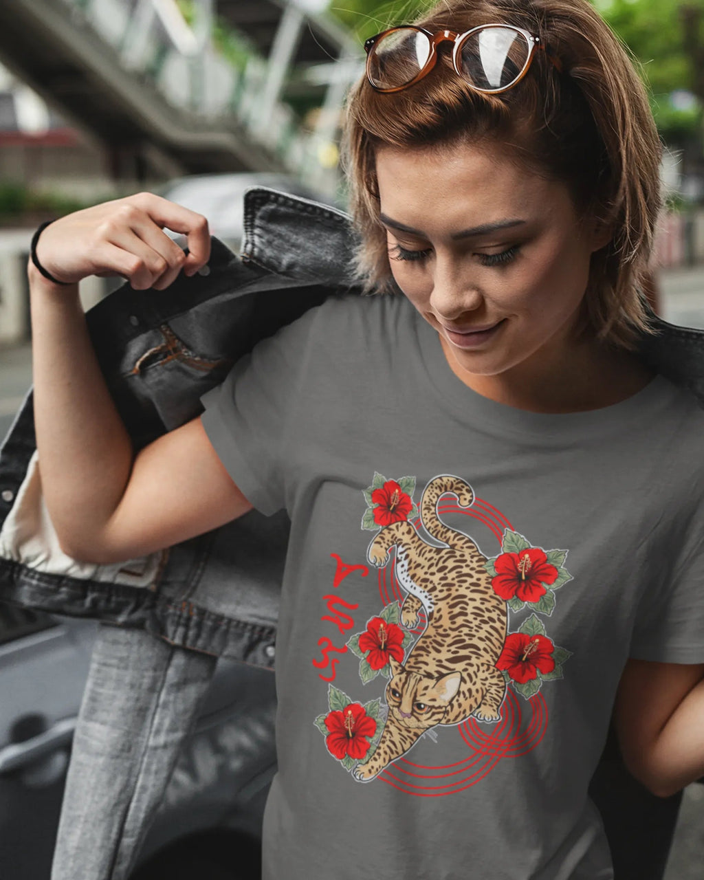 Half-Pinay woman on a city street wearing a bisaya shirt with Visayan leopard cat artwork