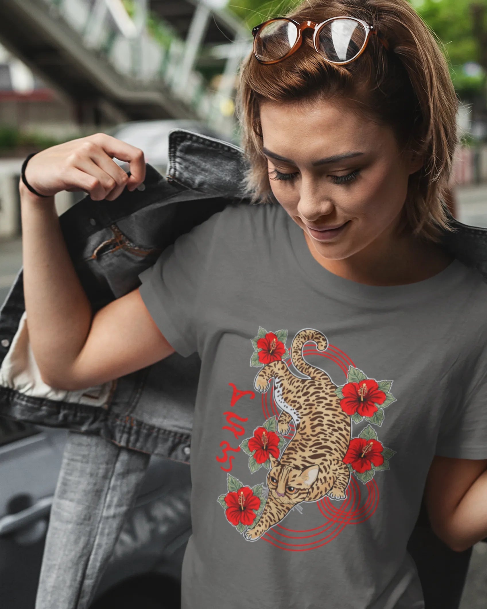 Half-Pinay woman on a city street wearing a bisaya shirt with Visayan leopard cat artwork