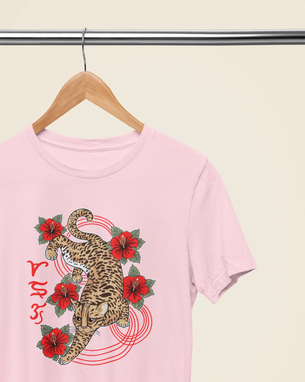 Soft pink philippines wildlife tee on a wooden hanger, Visayan leopard cat Badlit design