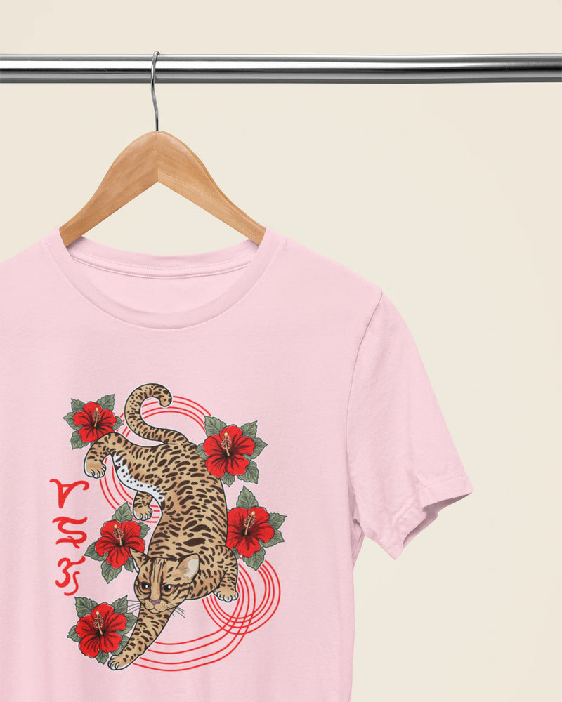 Soft pink philippines wildlife tee on a wooden hanger, Visayan leopard cat Badlit design