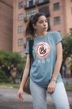 Woman wearing a blue unisex t-shirt with a graphic design showing the words Sugbo and Bisaya in pre-colonial Filipino script.