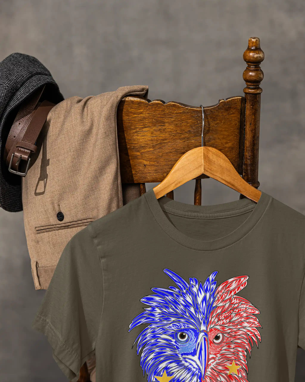 Army green Philippine Eagle Pilipinas Baybayin shirt hanging on a vintage chair