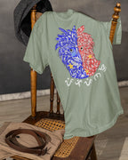 Sage green Philippine Eagle Pilipinas Baybayin tee draped on a vintage chair