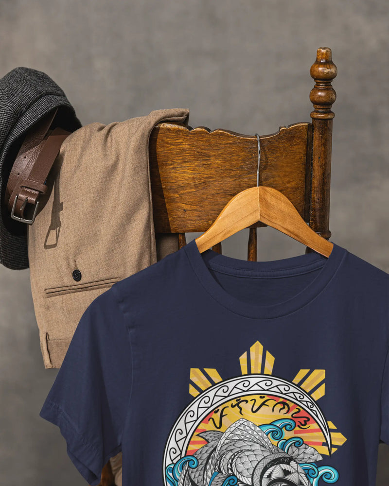 Navy Baybayin koi shirt hanging on a vintage chair, tribal wave art close-up.