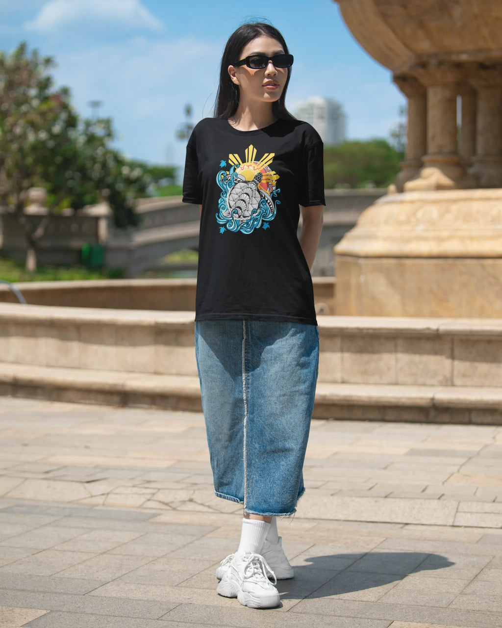 Baybayin Malaya Pawikan tee in black – styled outdoors by a Manila fountain