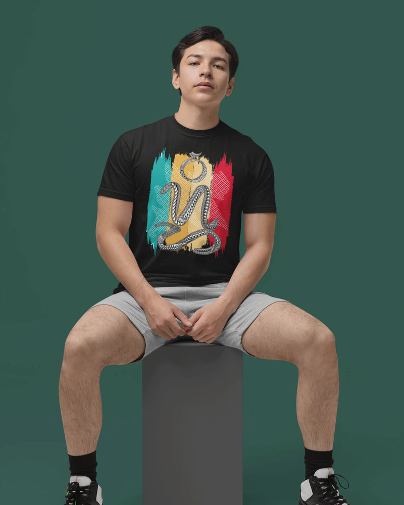 Man wearing a black badlit suwat bisaya t-shirt, seated on a studio cube
