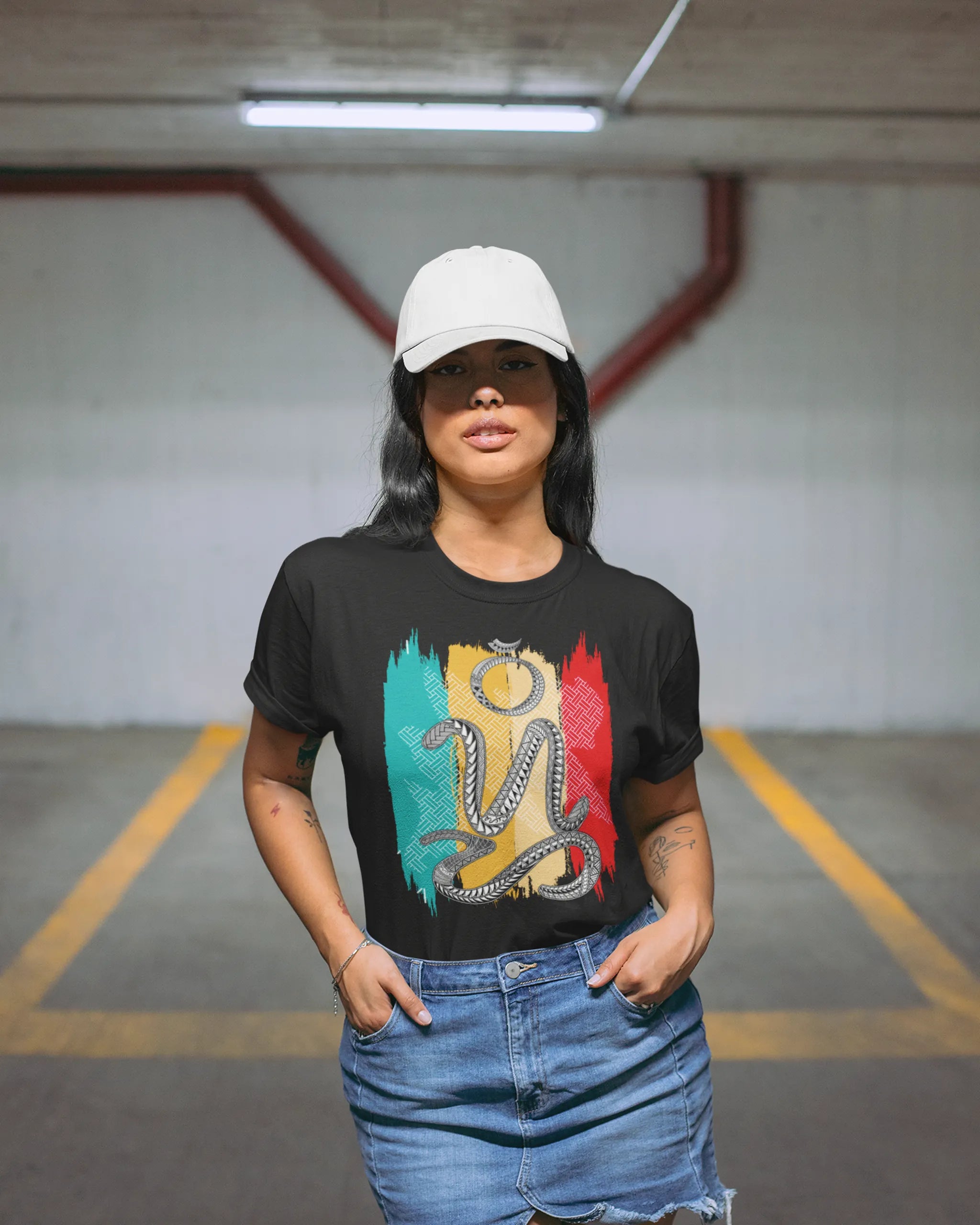 Woman wearing a black bisaya shirt with Badlit suwat script, in a parking garage