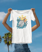 Baybayin Malaya Pawikan tee in white – held up against a palm-lined coastal sky